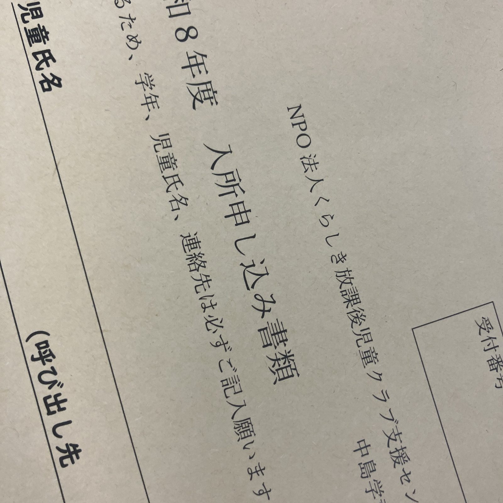 机に置かれた、未記入の入所申し込み書類